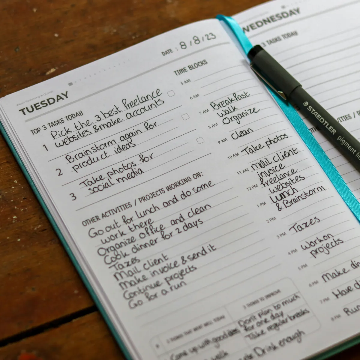 A notebook and pen on a kitchen counter for weekly meal planning